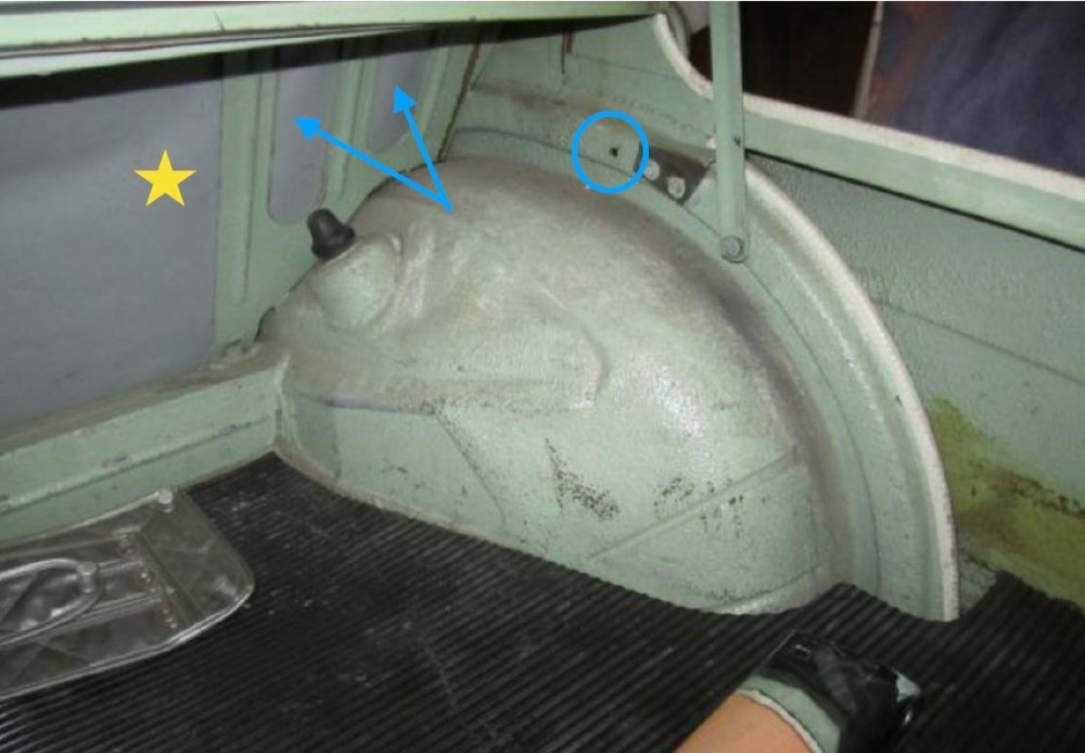 Figure 3 Rear bulkhead and wheelhouse of 1963 Neue Klasse 1500. Arrows indicate oval cutouts. The circle at the “vent and drain” box metal hole. Star in large bulkhead opening. Photo courtesy of BMW 2002 FAQ