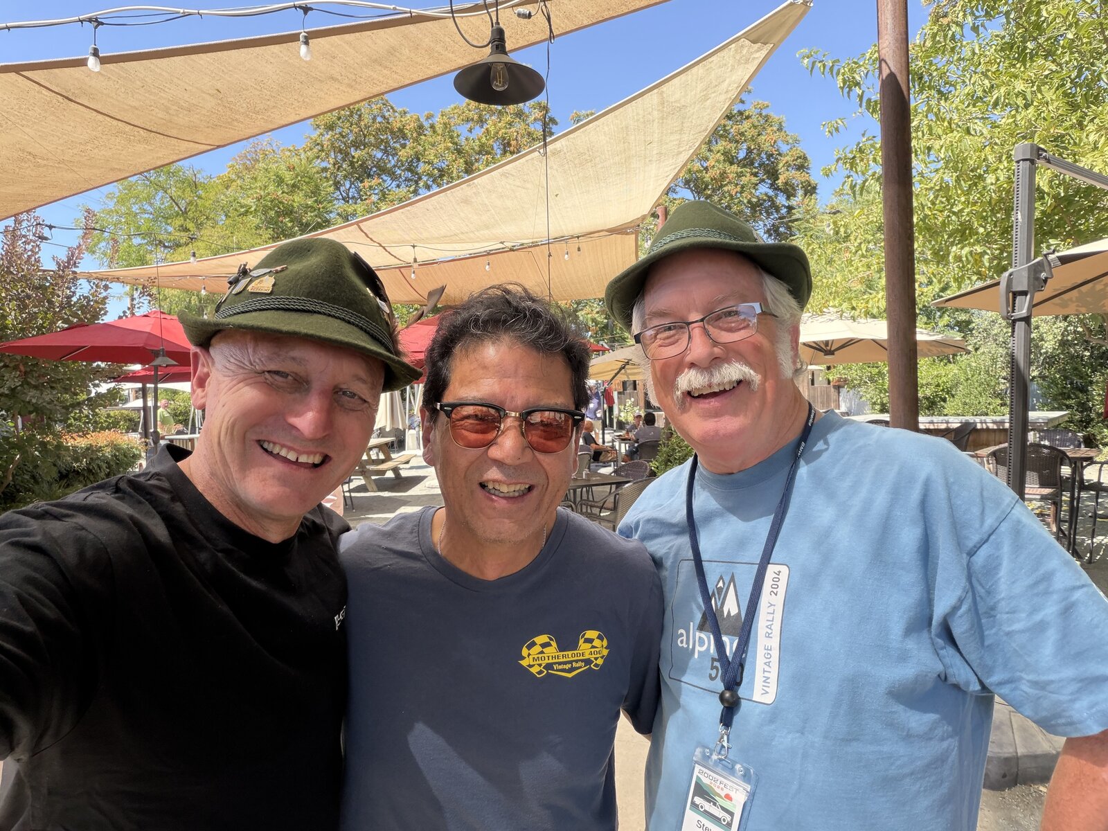 Friends posing together beneath the shade sails at lunch