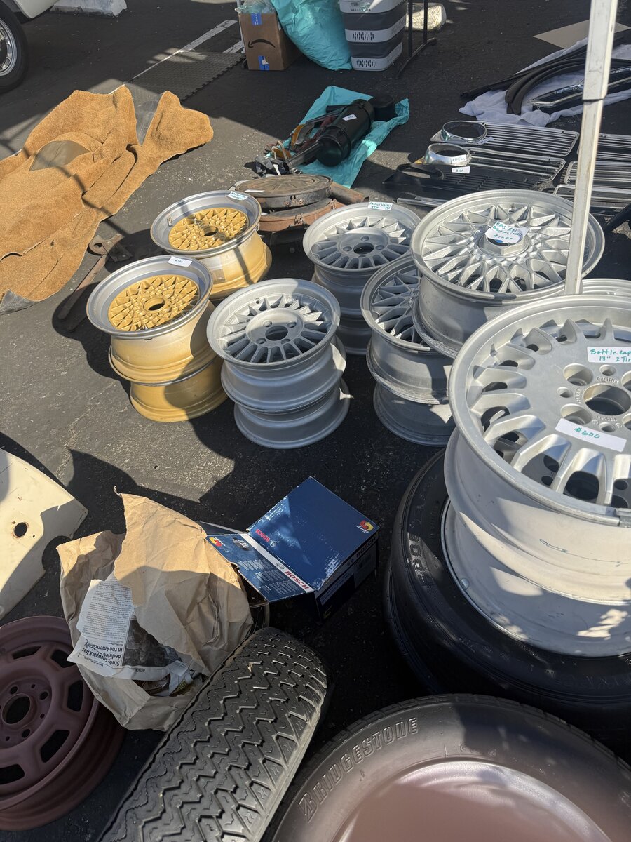Wheels and parts laid out for browsing at the swap meet