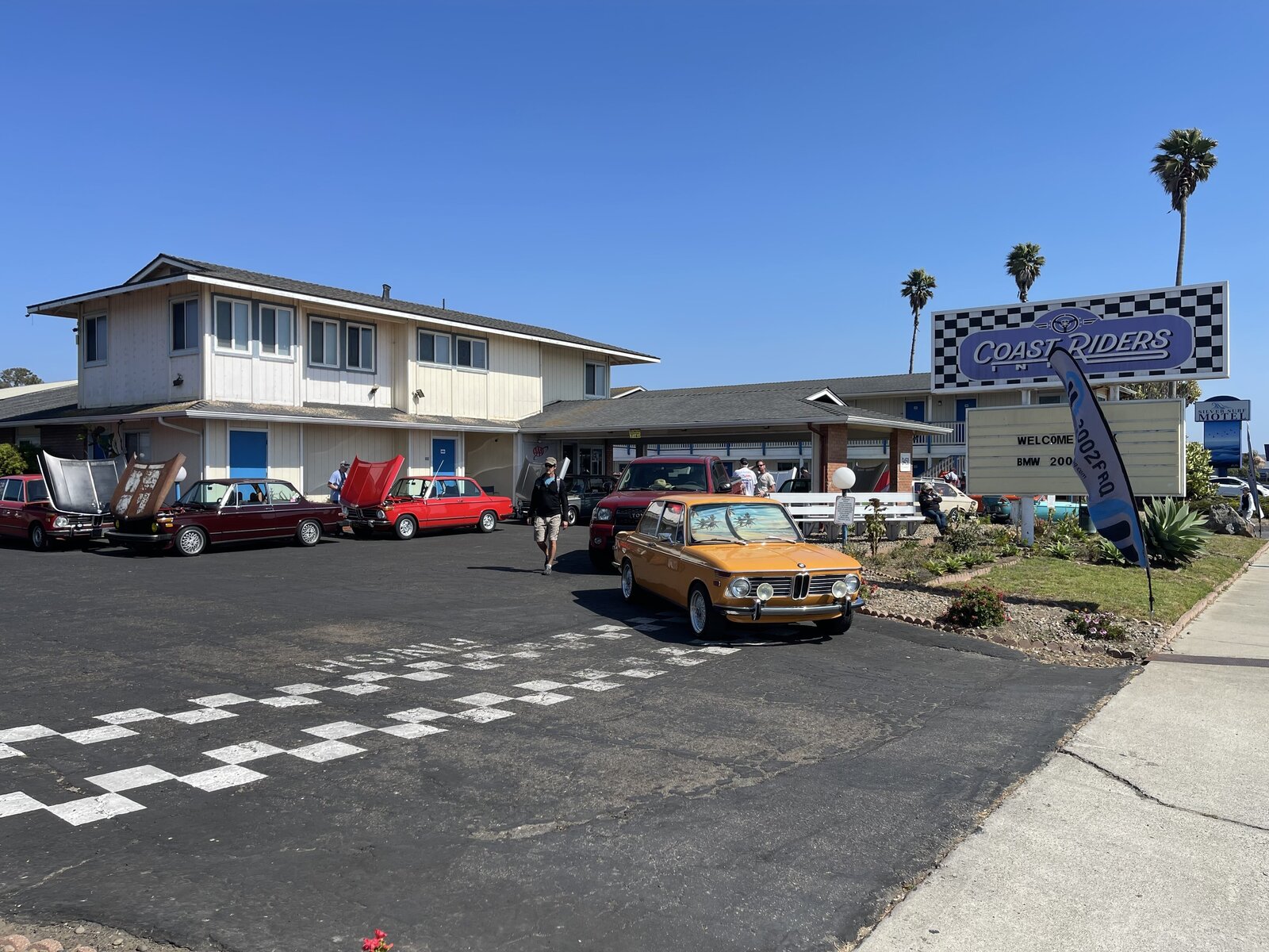 Classic BMWs gathered beside the Coast Riders Inn sign