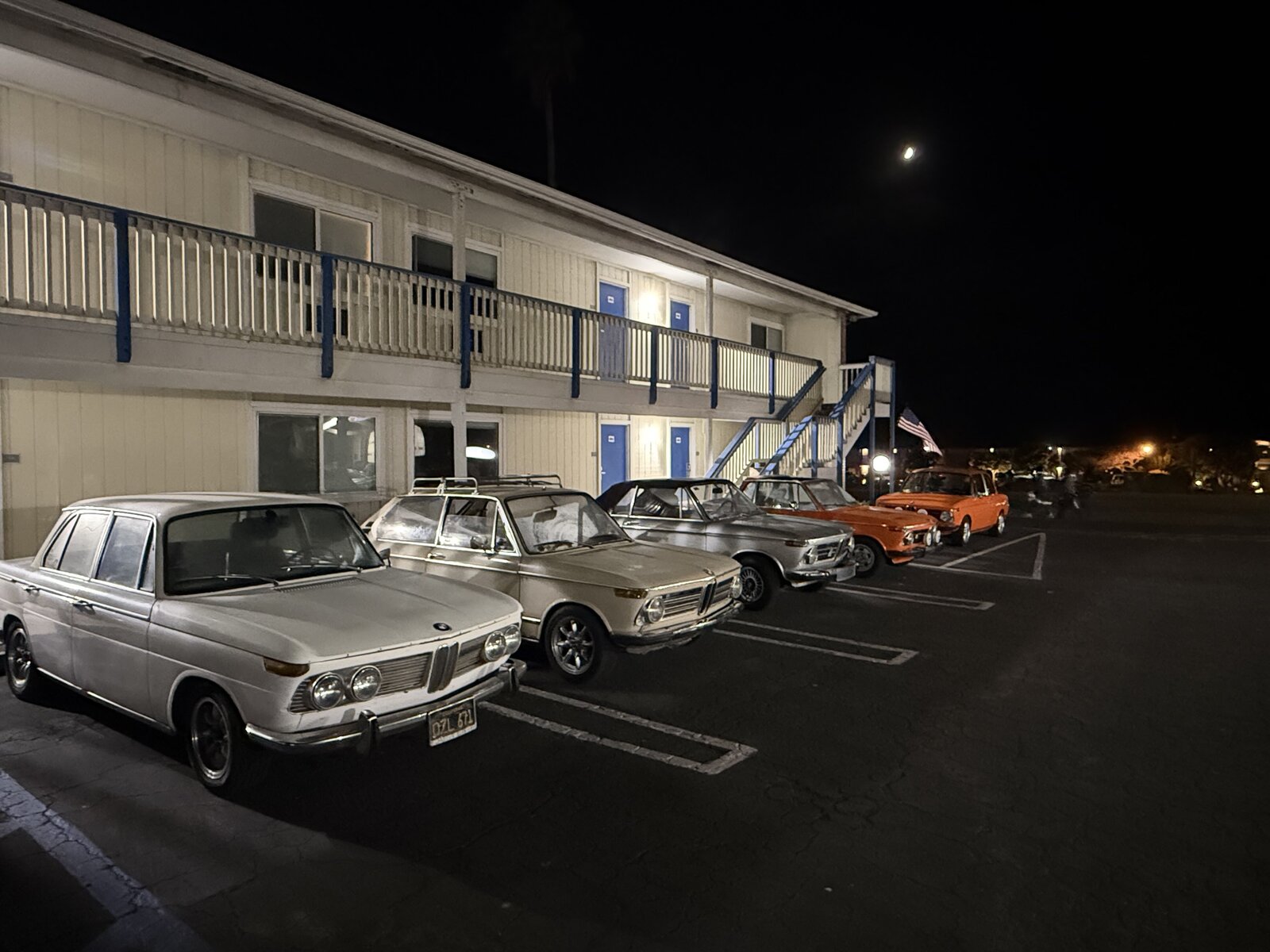 A row of classic BMWs outside Coast Riders Inn after dark